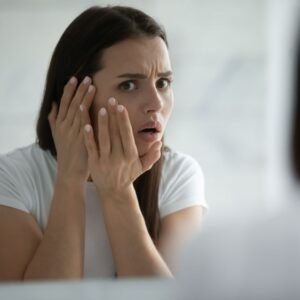 Funny skincare reaction image of a shocked girl realizing beginner skincare mistakes that damage skin and cause breakouts.